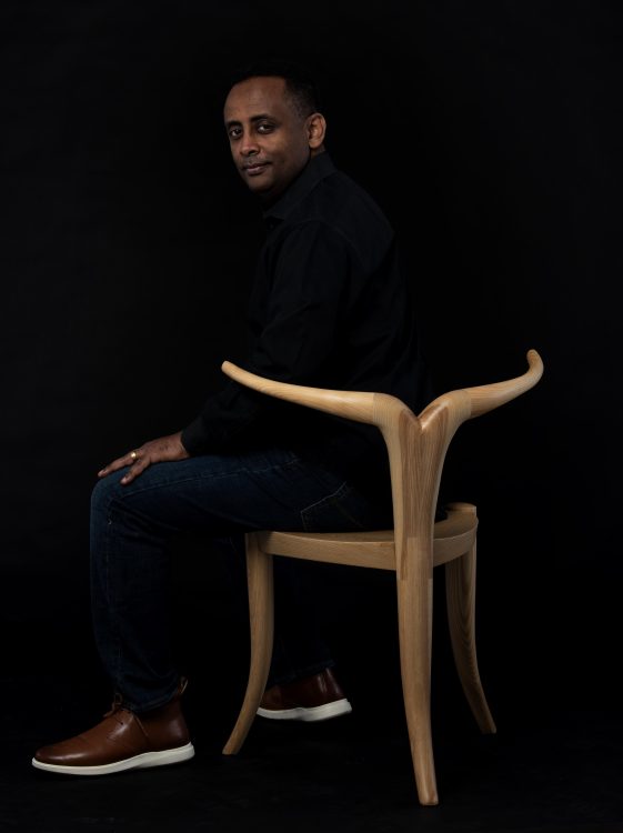 black man in sculptural chair 